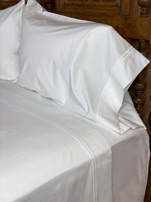 White sheets embroidered with double rows of satin stitch in "White" color.